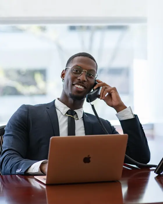 Ben Young on the phone at his desk with a laptop